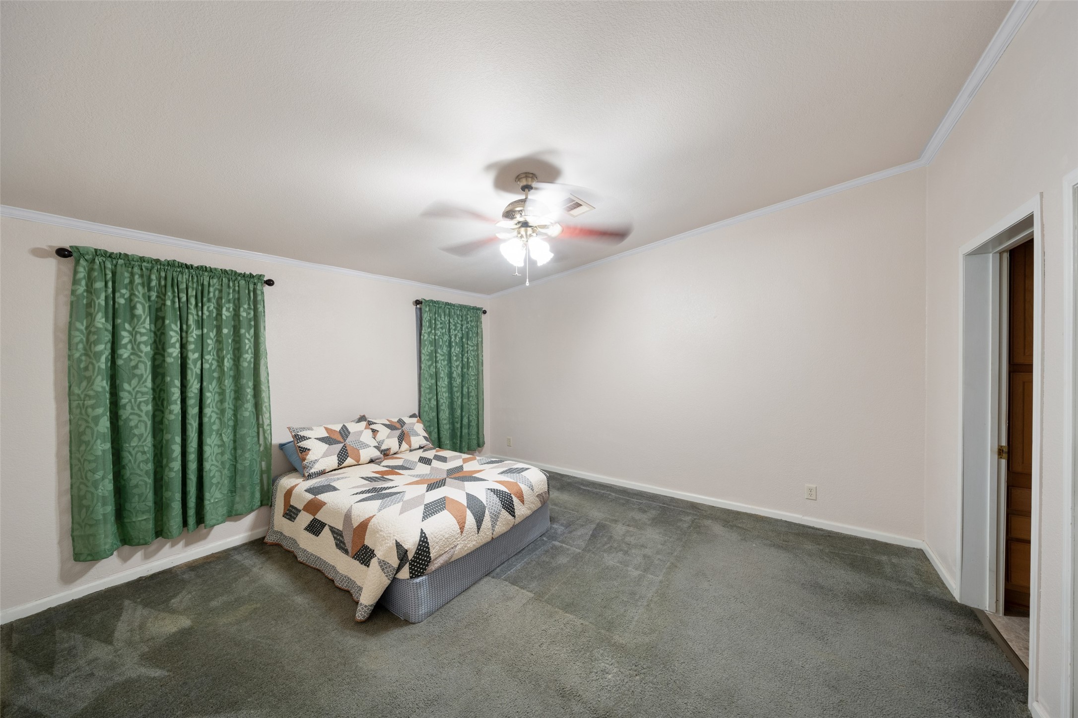 31351 Buckeye Road Waller, TX 77484 - Photo 24 of 36 a bed sitting in a spacious bedroom next to a window