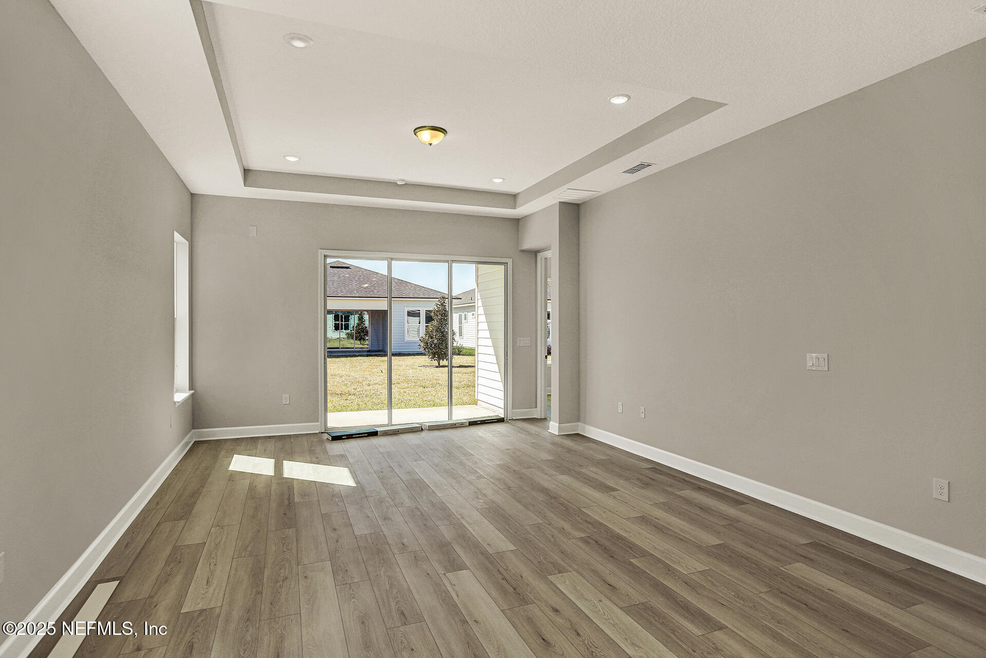 42 Tillia Trail St. Augustine, FL 32092 - Photo 16 of 18 a view of an empty room with wooden floor and a window