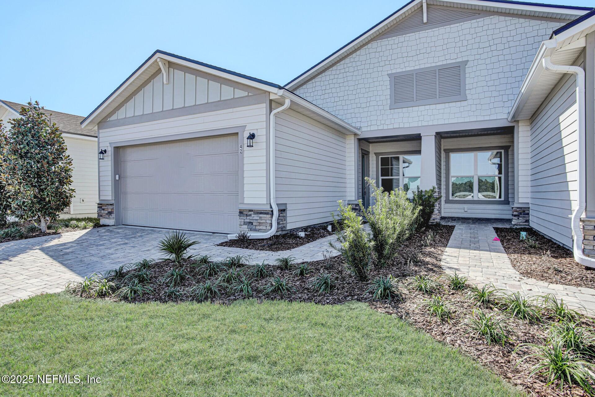 42 Tillia Trail St. Augustine, FL 32092 - Photo 3 of 18 a front view of house with yard and outdoor seating