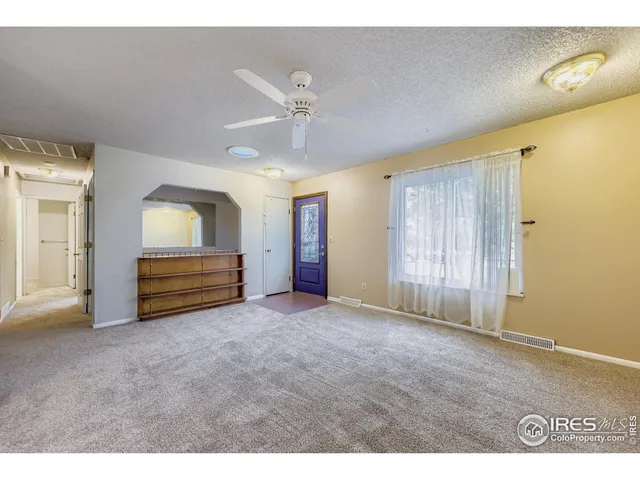 a view of an empty room with closet area