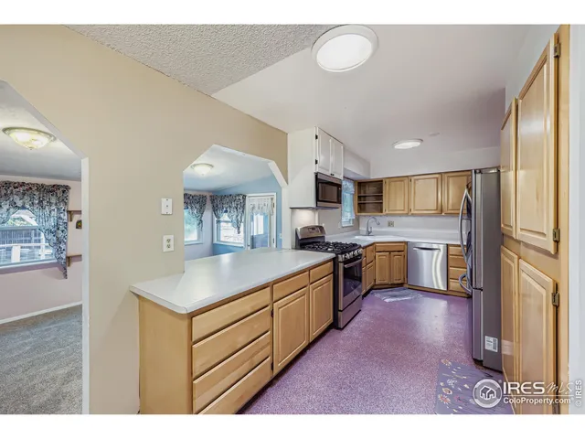 a kitchen with stainless steel appliances a sink stove and cabinets