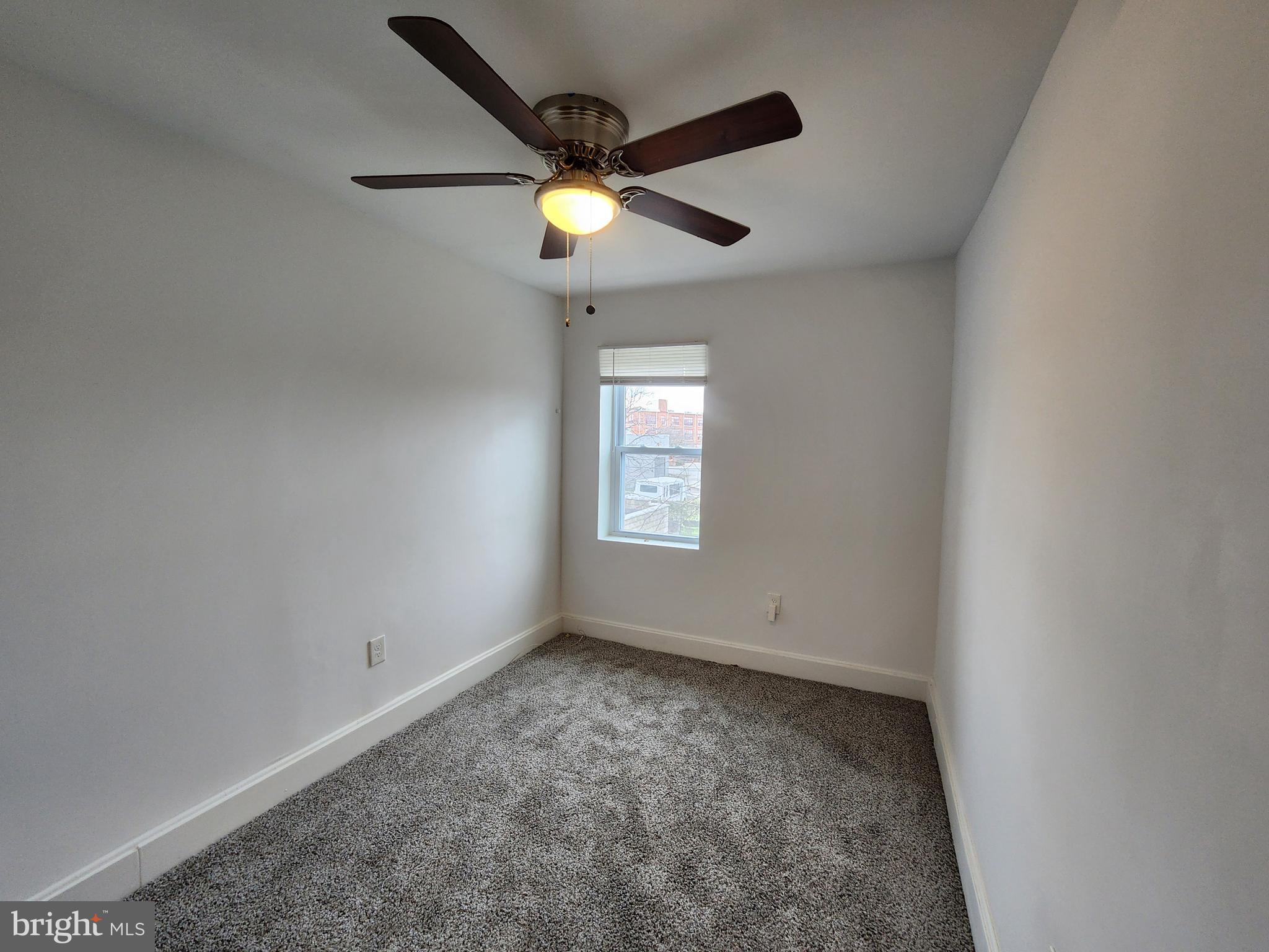 1213 East Lanvale Street Baltimore, MD 21202 - Photo 12 of 22 an empty room with ceiling fan and window
