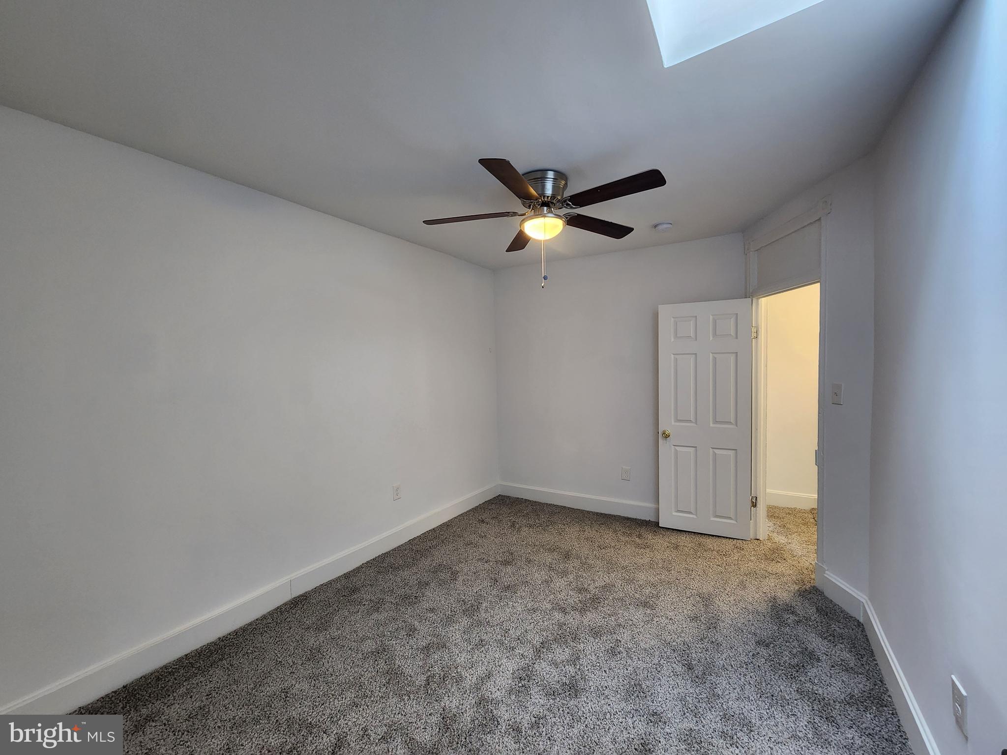 1213 East Lanvale Street Baltimore, MD 21202 - Photo 15 of 22 an empty room with a ceiling fan and a window