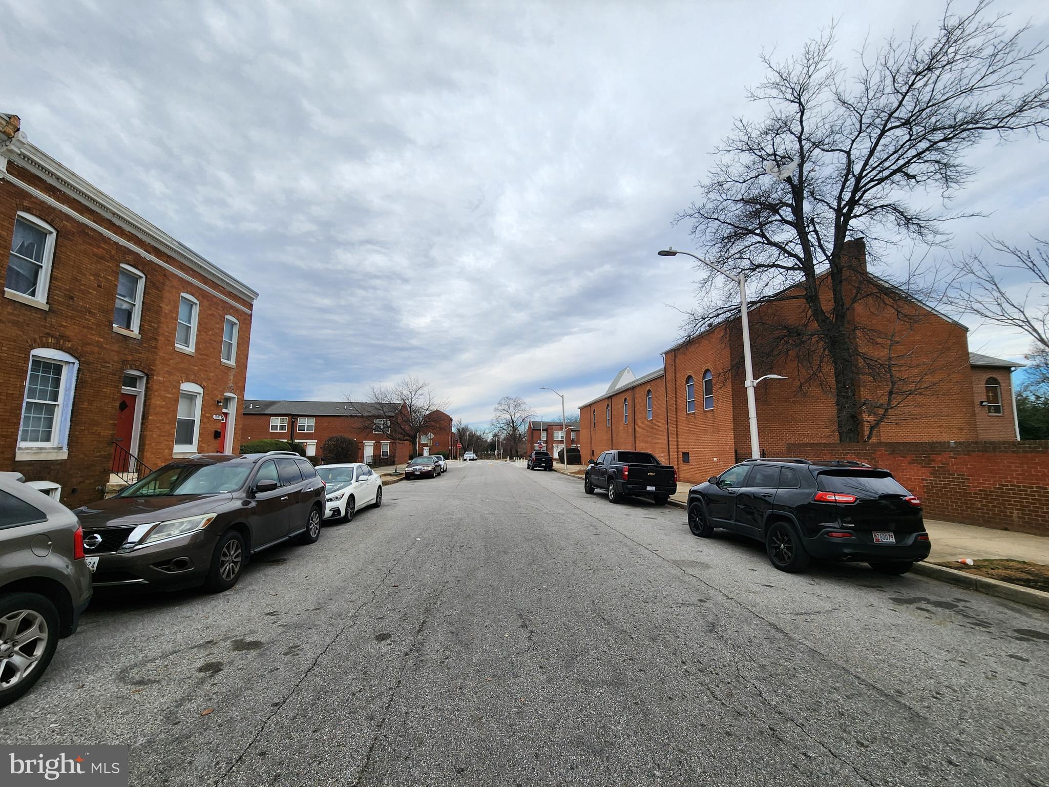 1213 East Lanvale Street Baltimore, MD 21202 - Photo 21 of 22 a couple of cars parked in front of a house
