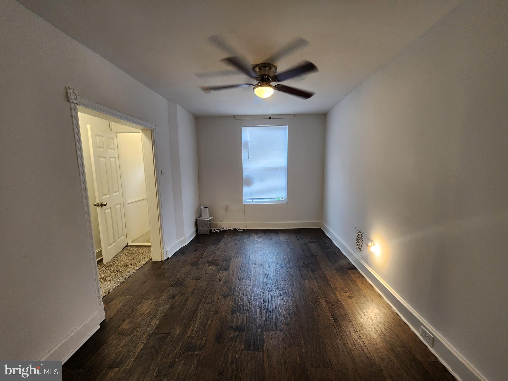 1213 East Lanvale Street Baltimore, MD 21202 - Photo 5 of 22 wooden floor in an empty room with a window