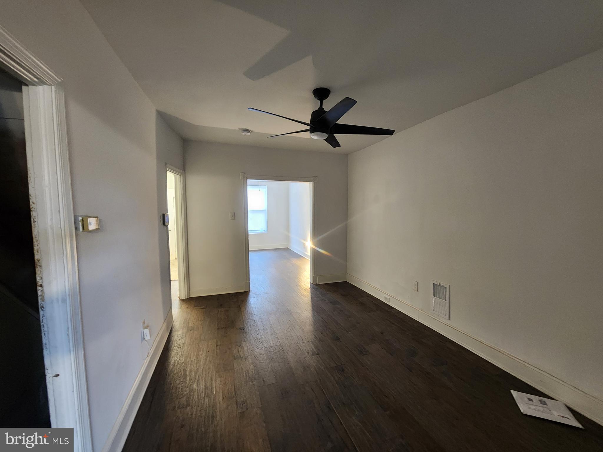 1213 East Lanvale Street Baltimore, MD 21202 - Photo 7 of 22 wooden floor in an empty room with a window
