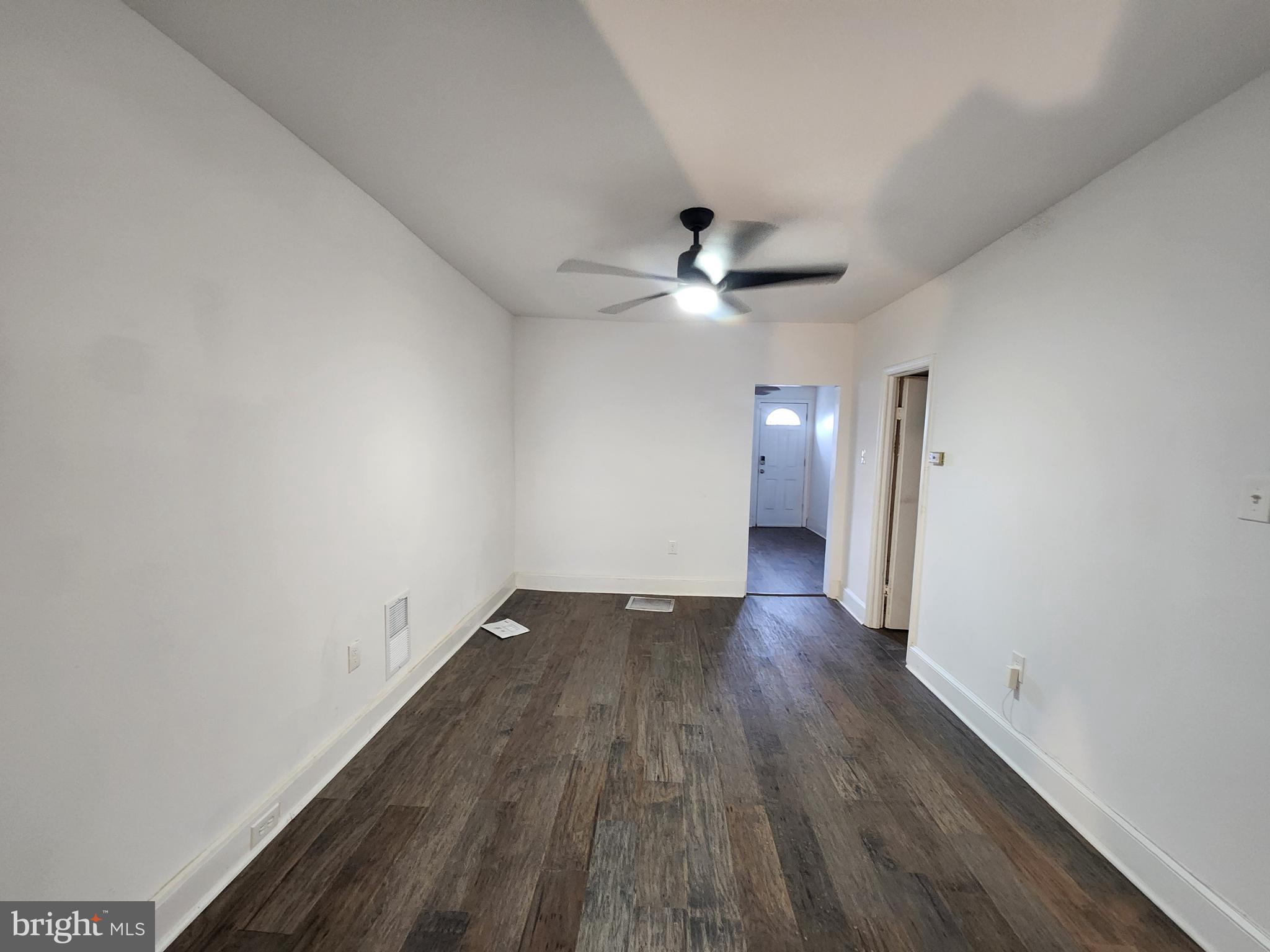 1213 East Lanvale Street Baltimore, MD 21202 - Photo 8 of 22 a view of an empty room with wooden floor