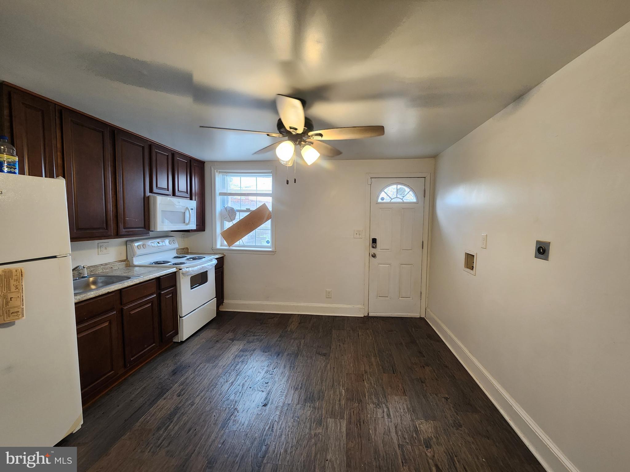 1213 East Lanvale Street Baltimore, MD 21202 - Photo 10 of 22 a kitchen with granite countertop a stove cabinets and wooden floor