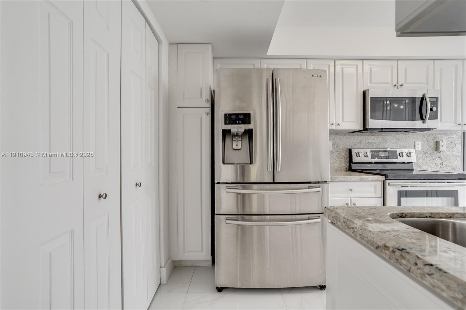 3500 Mystic Pointe Drive, Unit 1205 Aventura, FL 33180 - Photo 16 of 35 a white refrigerator freezer sitting in a kitchen