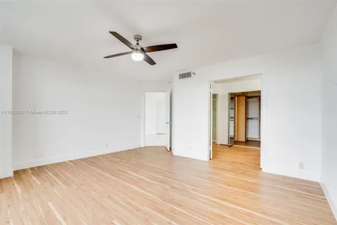 a view of room with window and ceiling fan
