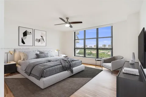 a spacious bedroom with a bed couch and a large window
