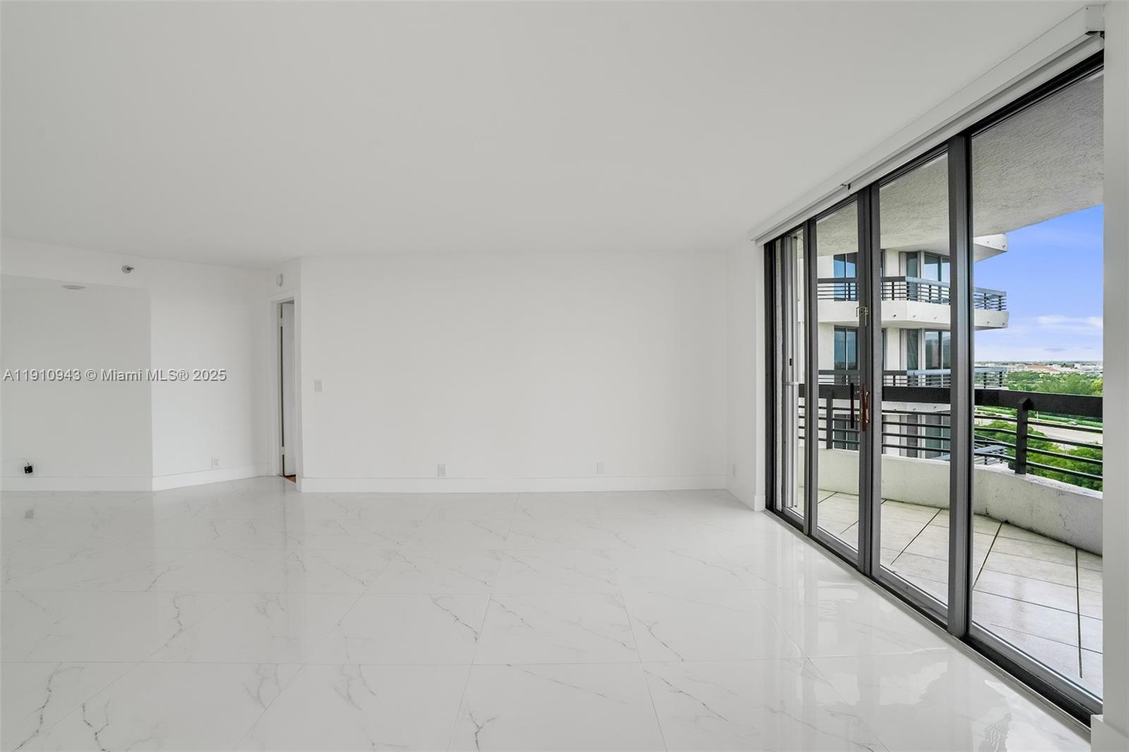 3500 Mystic Pointe Drive, Unit 1205 Aventura, FL 33180 - Photo 9 of 35 a view of an empty room with glass door