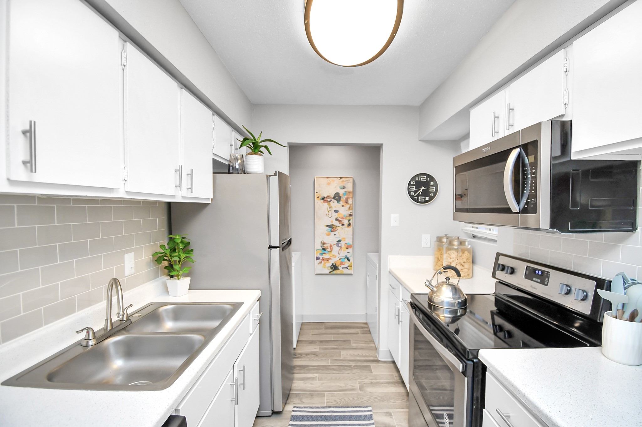 2701 West Bellfort Avenue, Unit 1001 Houston, TX 77054 - Photo 10 of 44 a kitchen with stainless steel appliances a sink a stove a microwave a refrigerator and cabinets