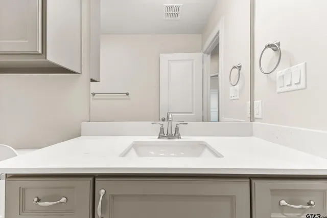 a bathroom with a sink toilet vanity and tub