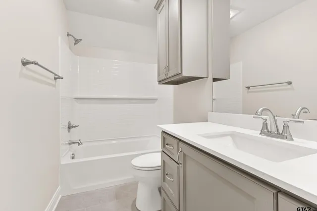 an empty room with a ceiling fan and a window