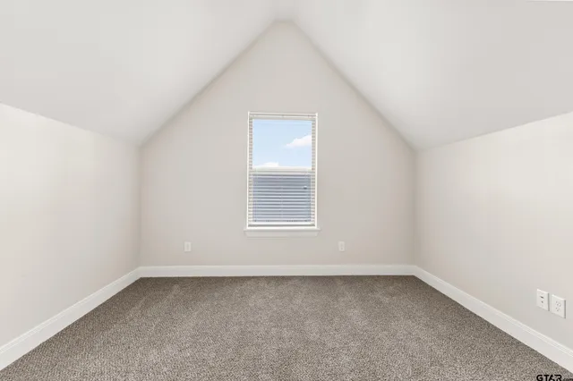 an empty room with a empty space and windows