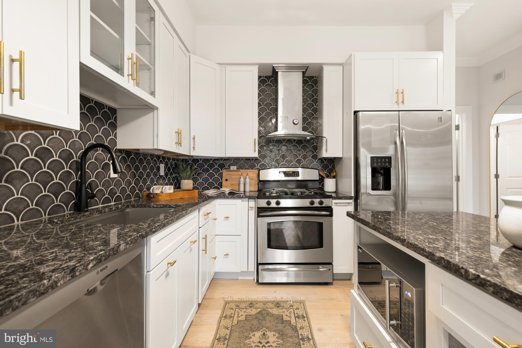 1464 Harvard Street Northwest, Unit 3 Washington, DC 20009 - Photo 17 of 24 a kitchen with stainless steel appliances granite countertop a sink stove and refrigerator