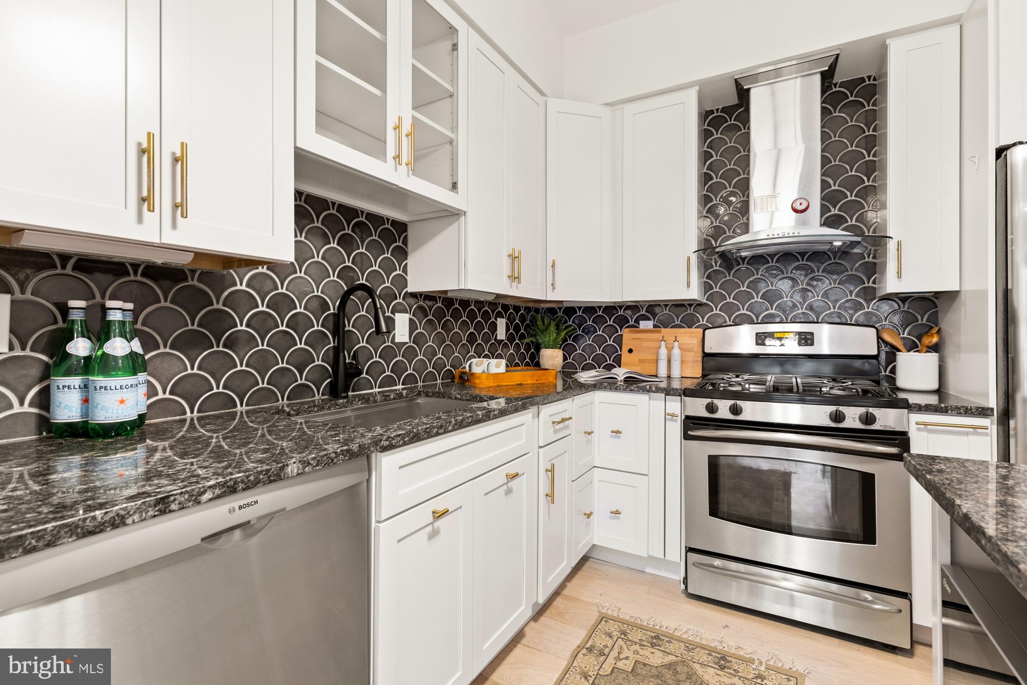 1464 Harvard Street Northwest, Unit 3 Washington, DC 20009 - Photo 18 of 24 a kitchen with stainless steel appliances granite countertop a sink stove and cabinets