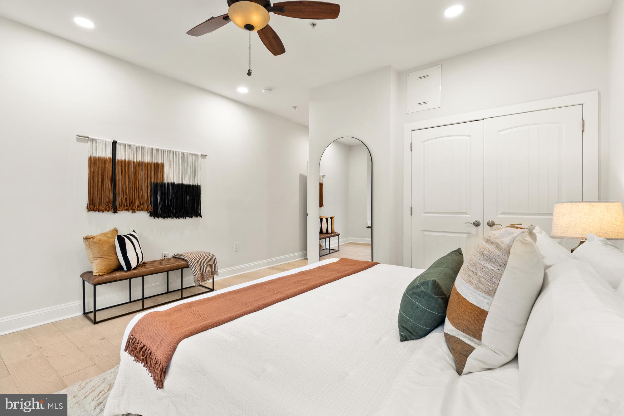 1464 Harvard Street Northwest, Unit 3 Washington, DC 20009 - Photo 22 of 24 a bedroom with a bed mirror and a flat screen tv
