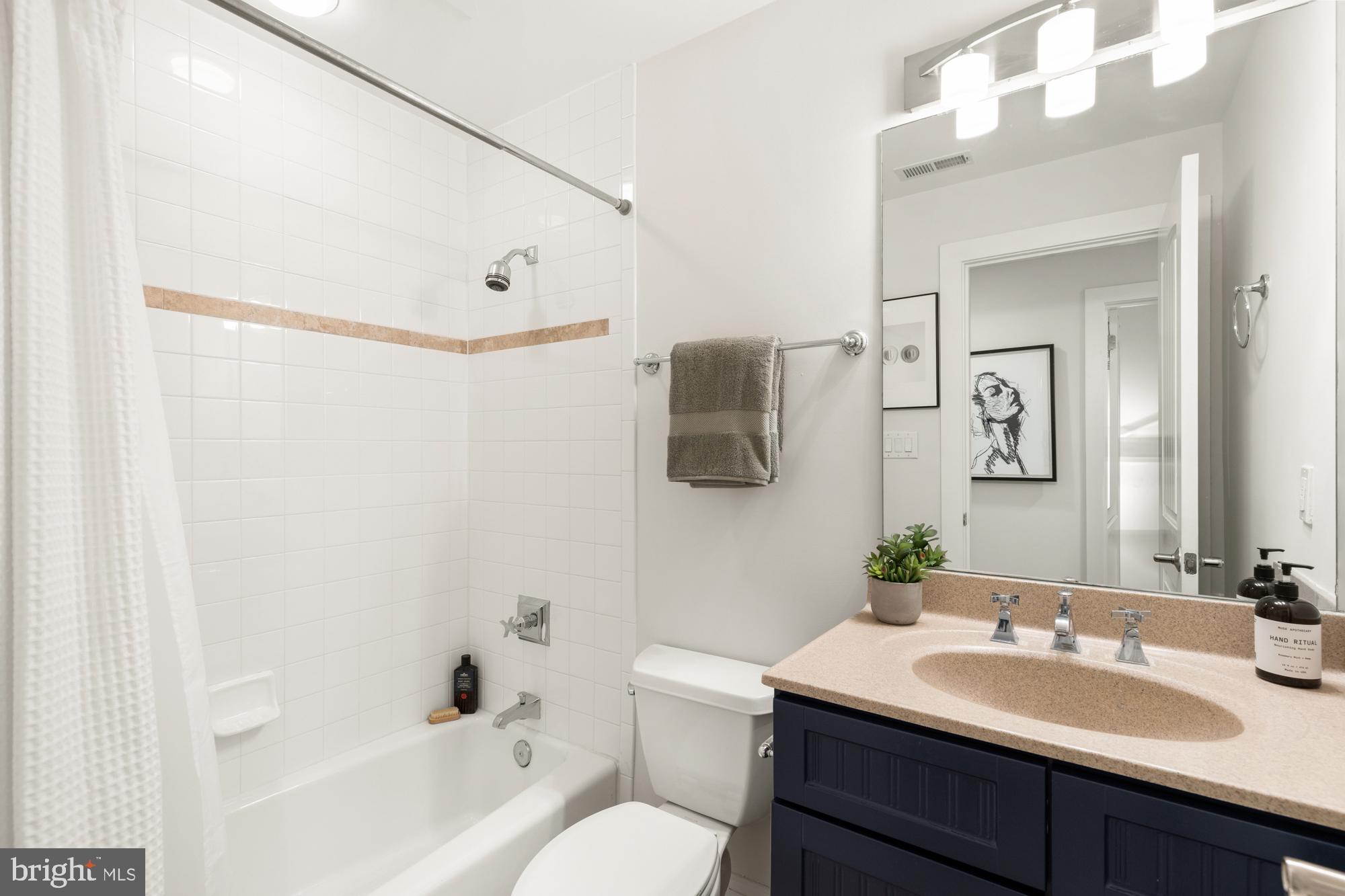 1464 Harvard Street Northwest, Unit 3 Washington, DC 20009 - Photo 7 of 24 a bathroom with a sink vanity mirror and toilet