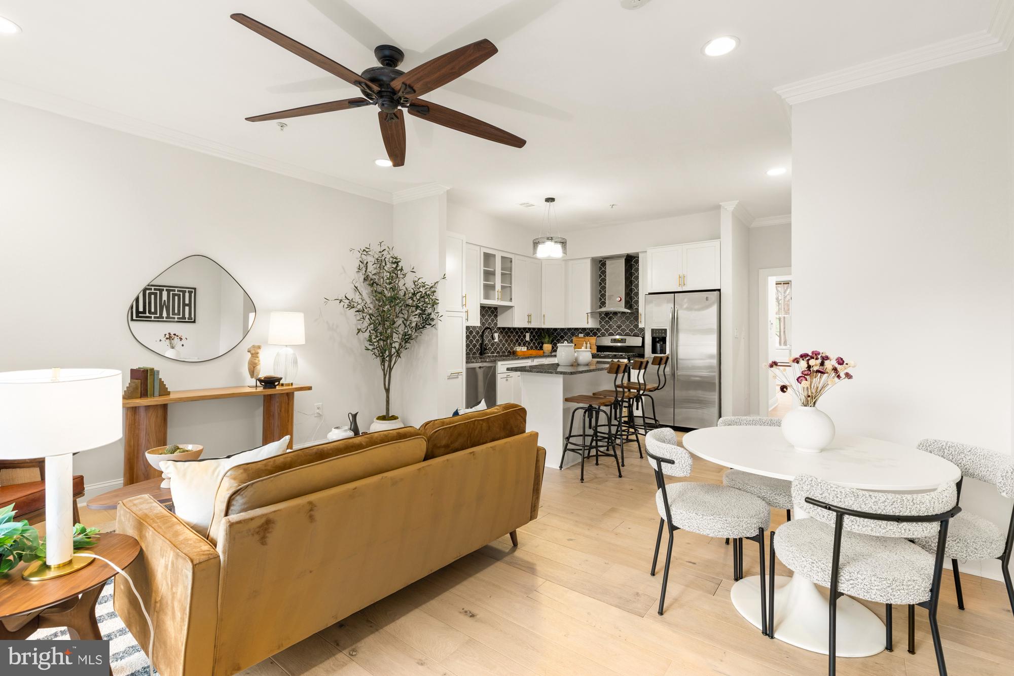 1464 Harvard Street Northwest, Unit 3 Washington, DC 20009 - Photo 8 of 24 a living room with furniture kitchen view and a chandelier