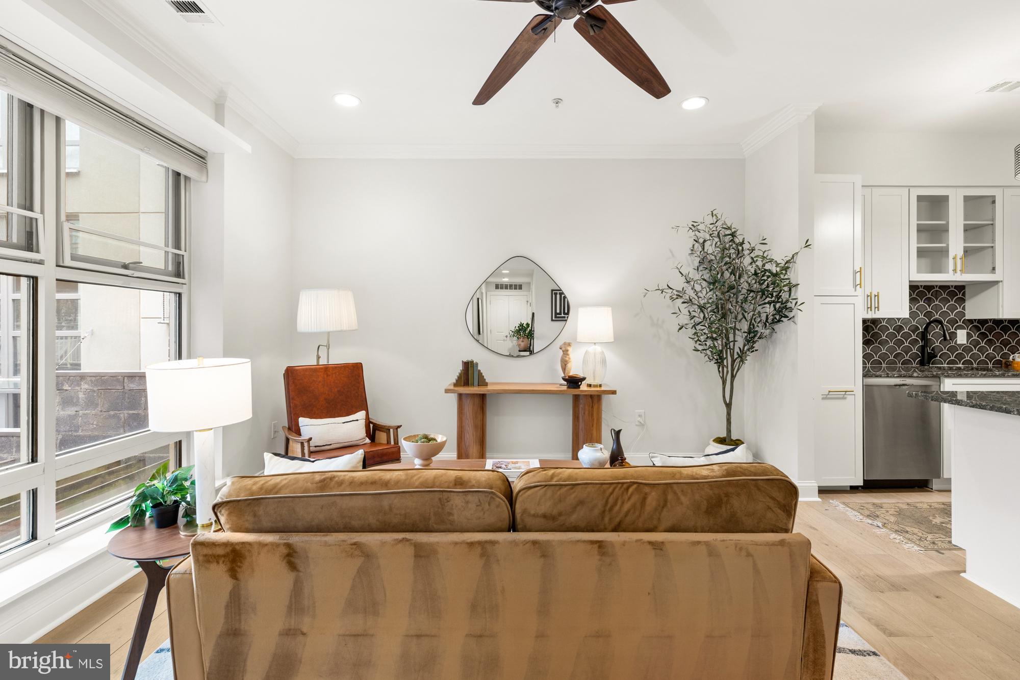 1464 Harvard Street Northwest, Unit 3 Washington, DC 20009 - Photo 10 of 24 a living room with furniture a large window with potted plants