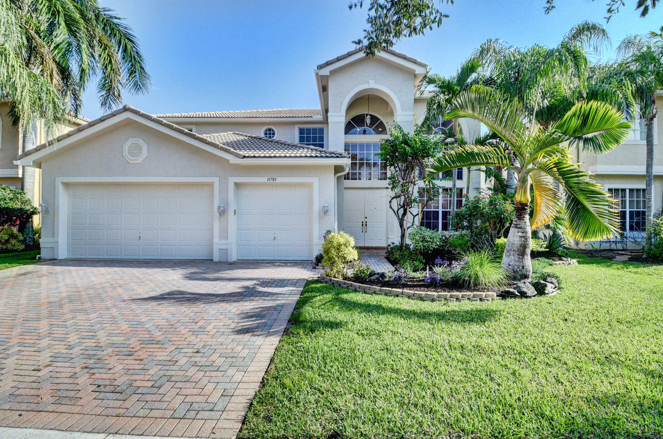 11785 Preservation Lane Boca Raton, FL 33498 - Photo 1 of 53 a front view of a house with a yard and garage