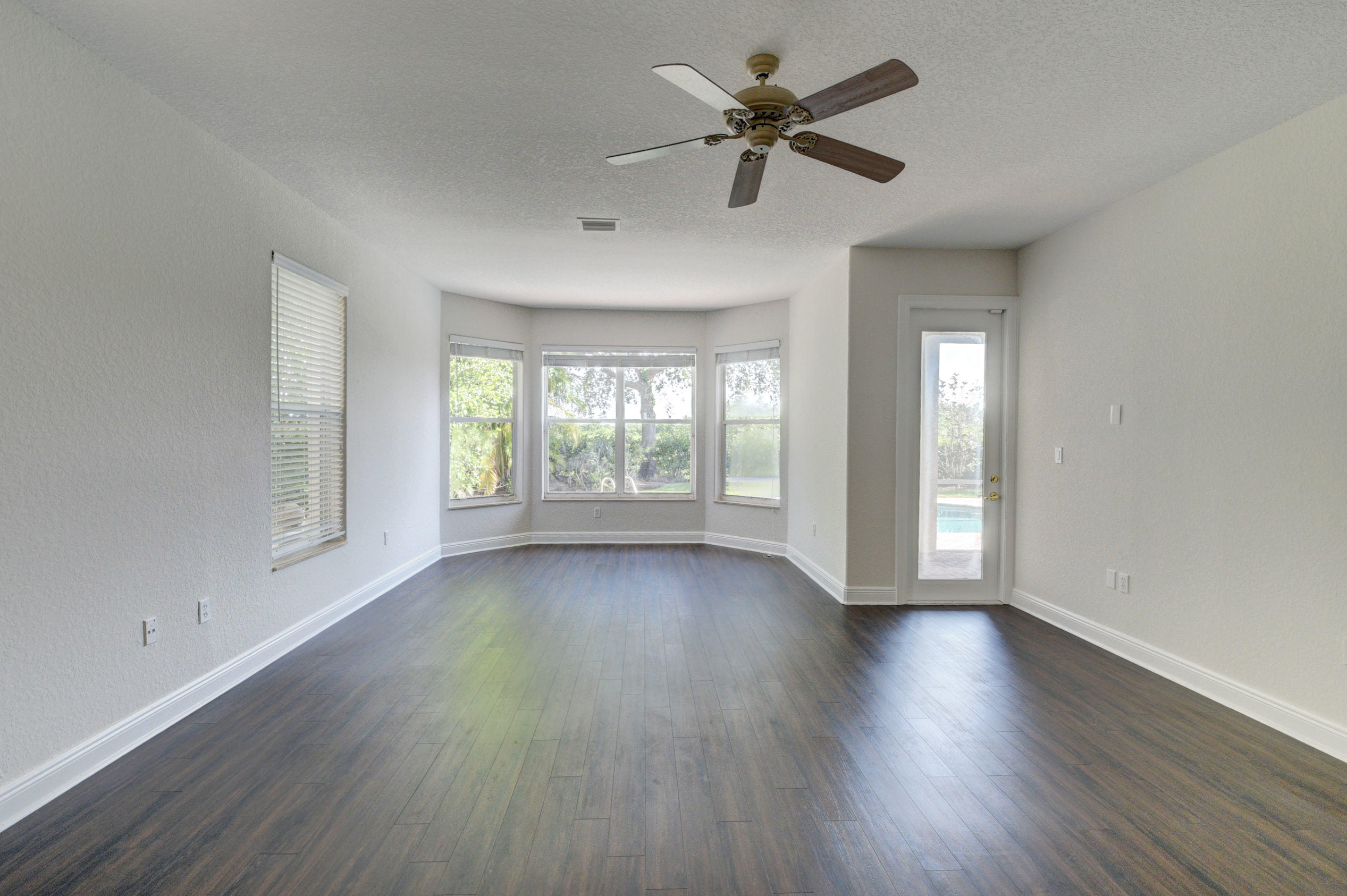 11785 Preservation Lane Boca Raton, FL 33498 - Photo 15 of 53 a view of an empty room with a window and wooden floor