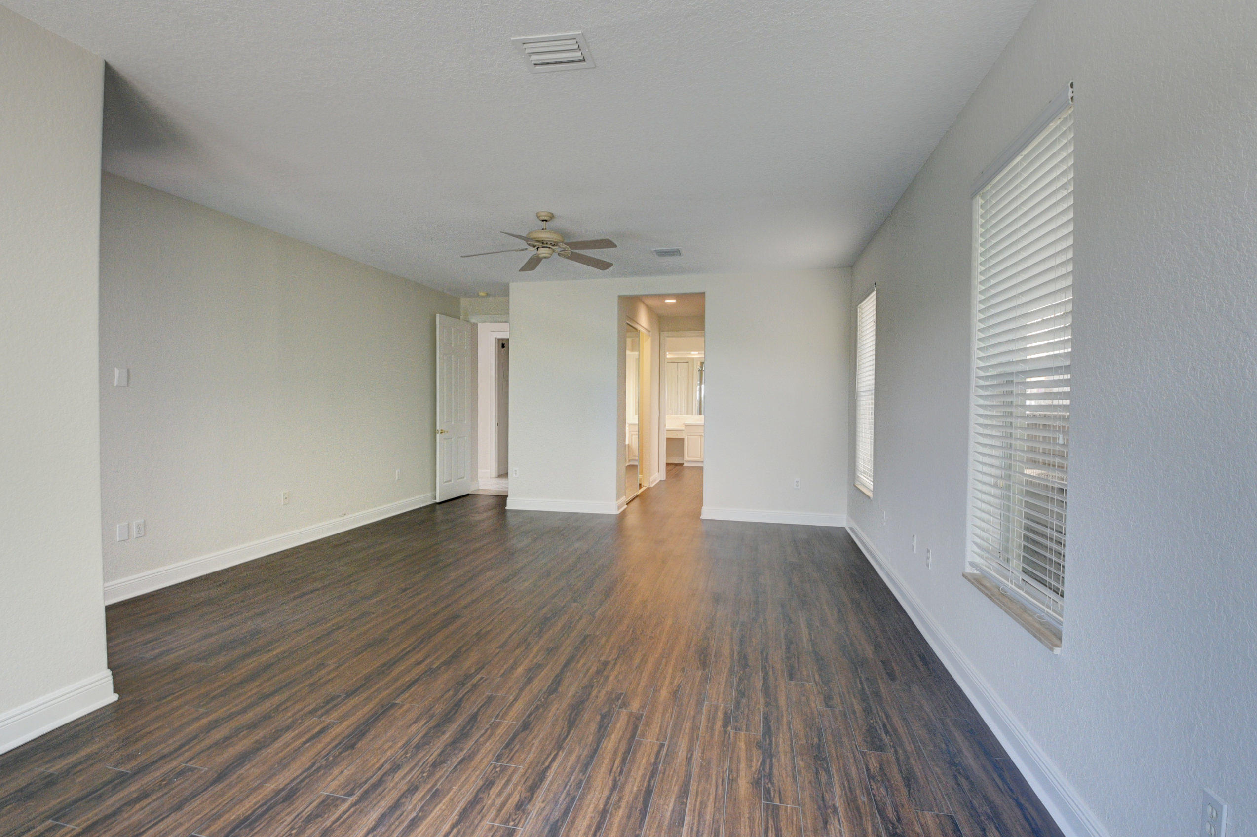 11785 Preservation Lane Boca Raton, FL 33498 - Photo 16 of 53 an empty room with wooden floor and windows