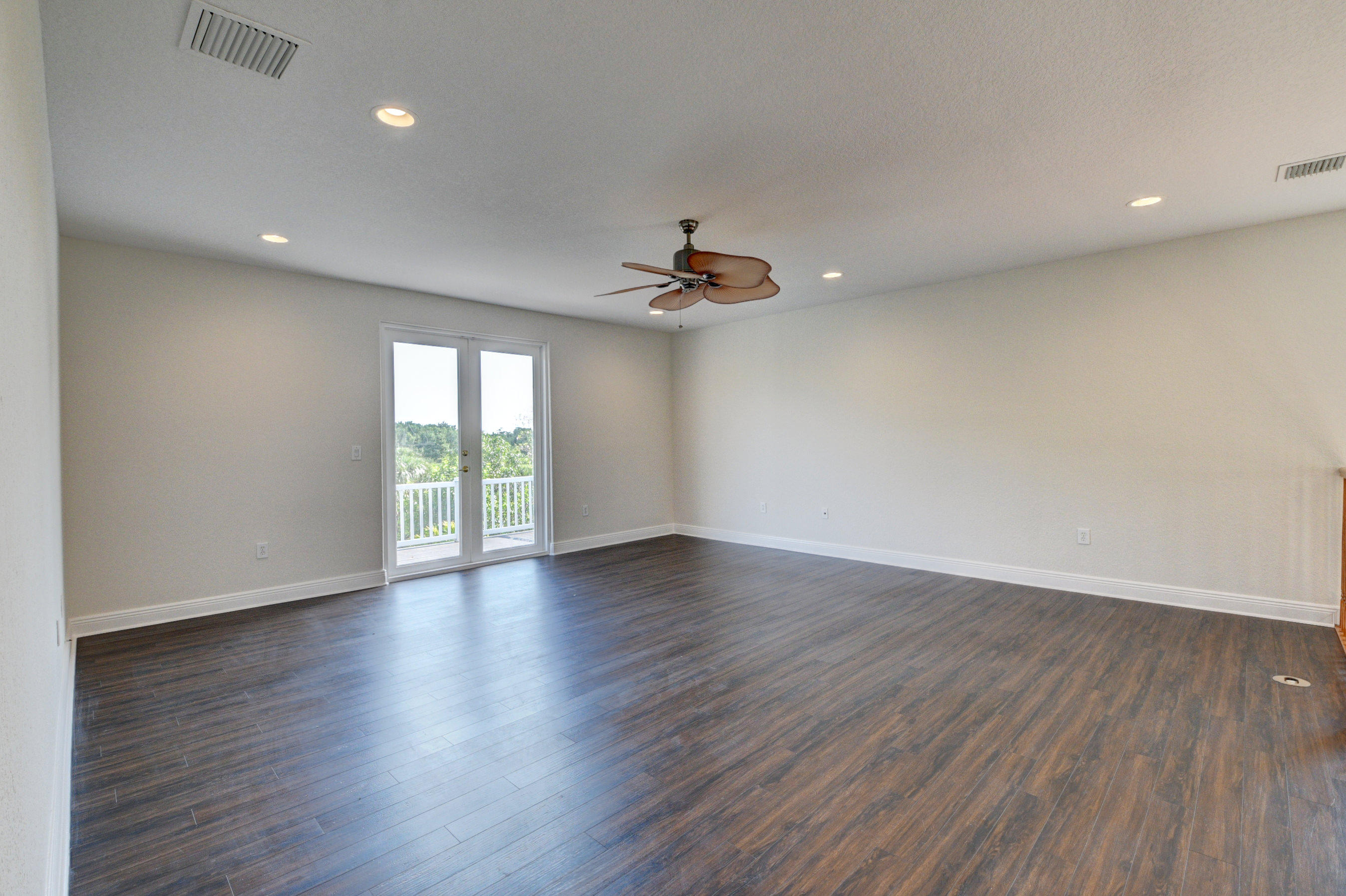 11785 Preservation Lane Boca Raton, FL 33498 - Photo 23 of 53 a view of an empty room with wooden floor and a window