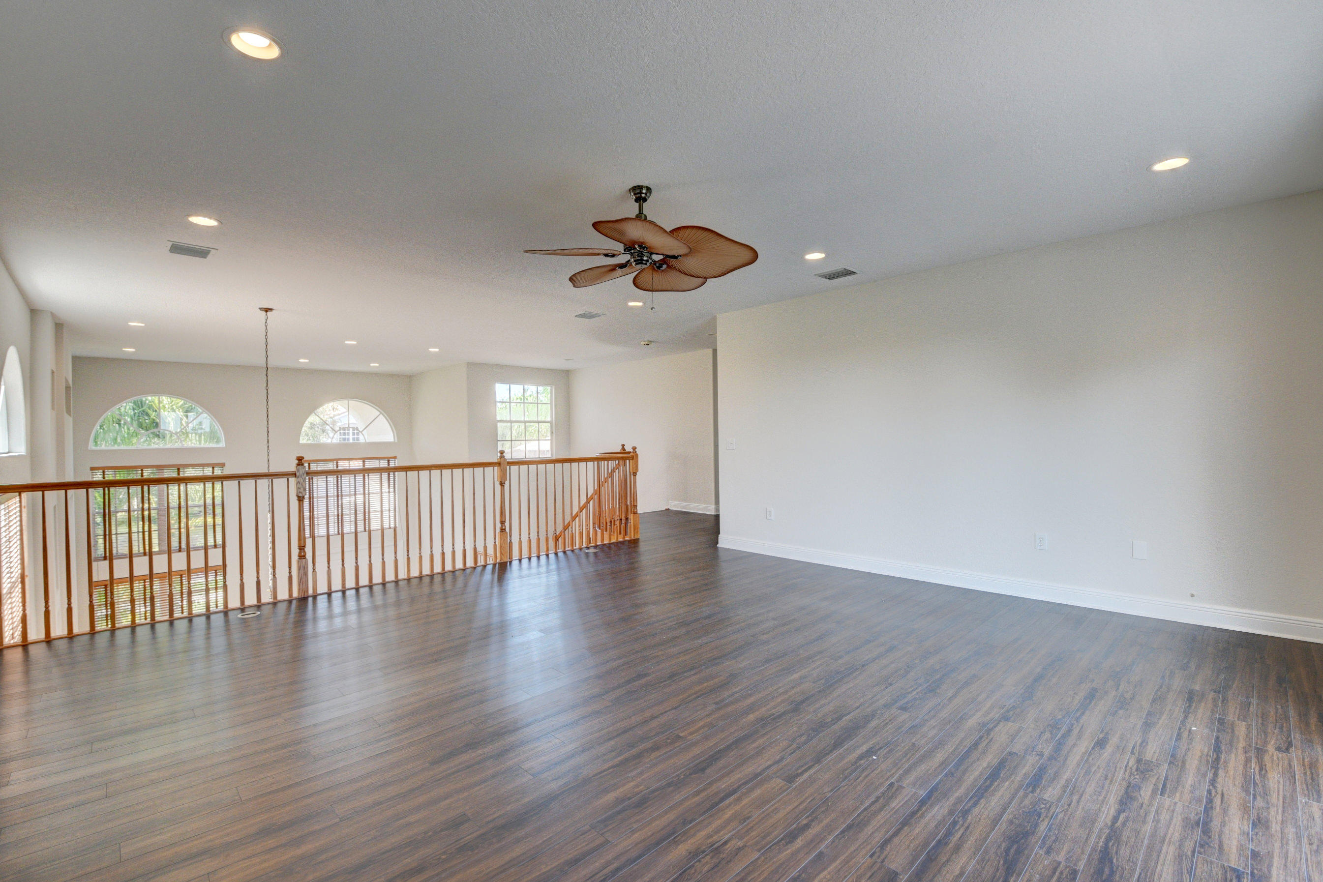 11785 Preservation Lane Boca Raton, FL 33498 - Photo 26 of 53 a view of a room with wooden floor and a ceiling fan