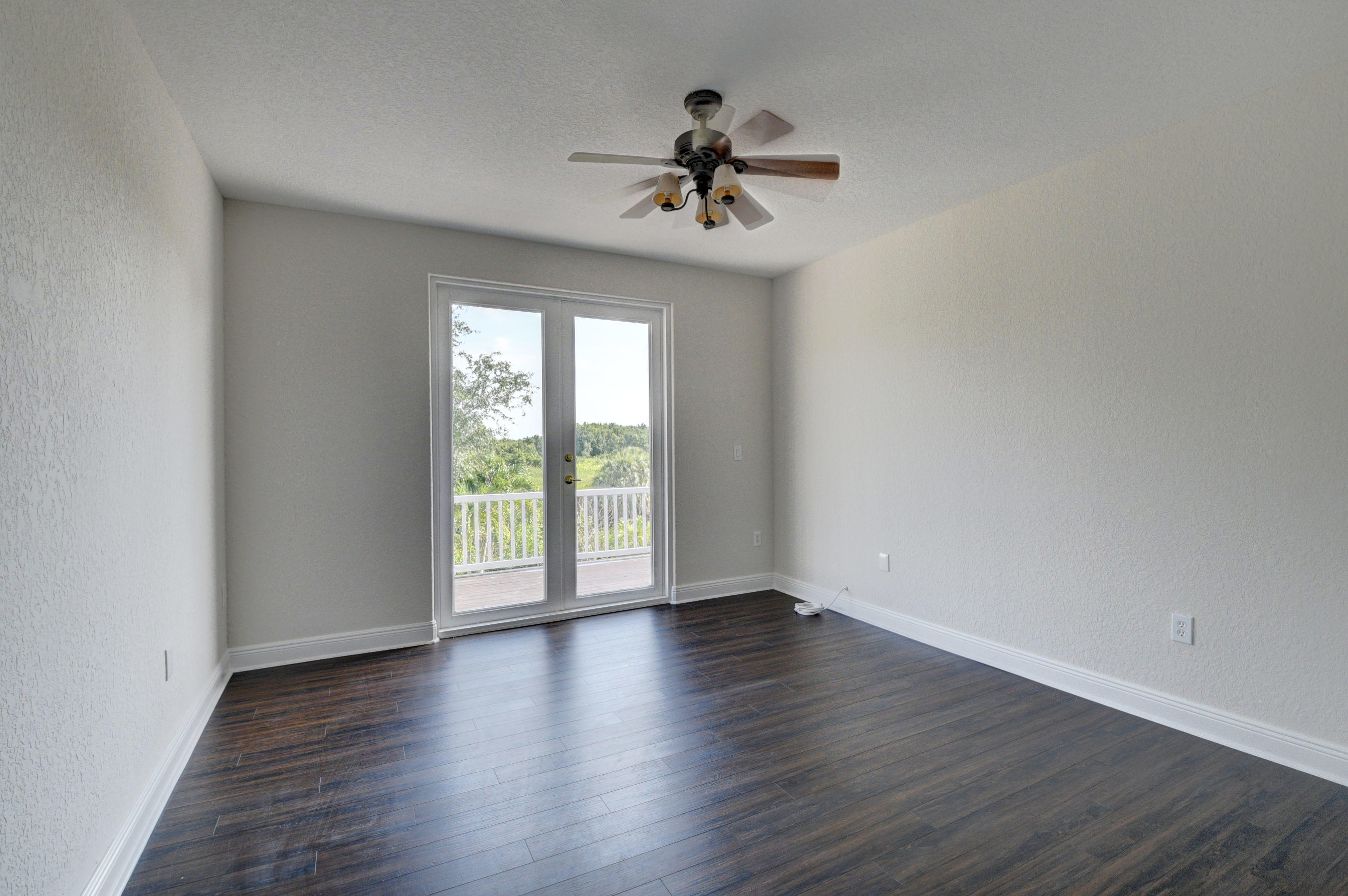 11785 Preservation Lane Boca Raton, FL 33498 - Photo 27 of 53 a view of an empty room with wooden floor and a window
