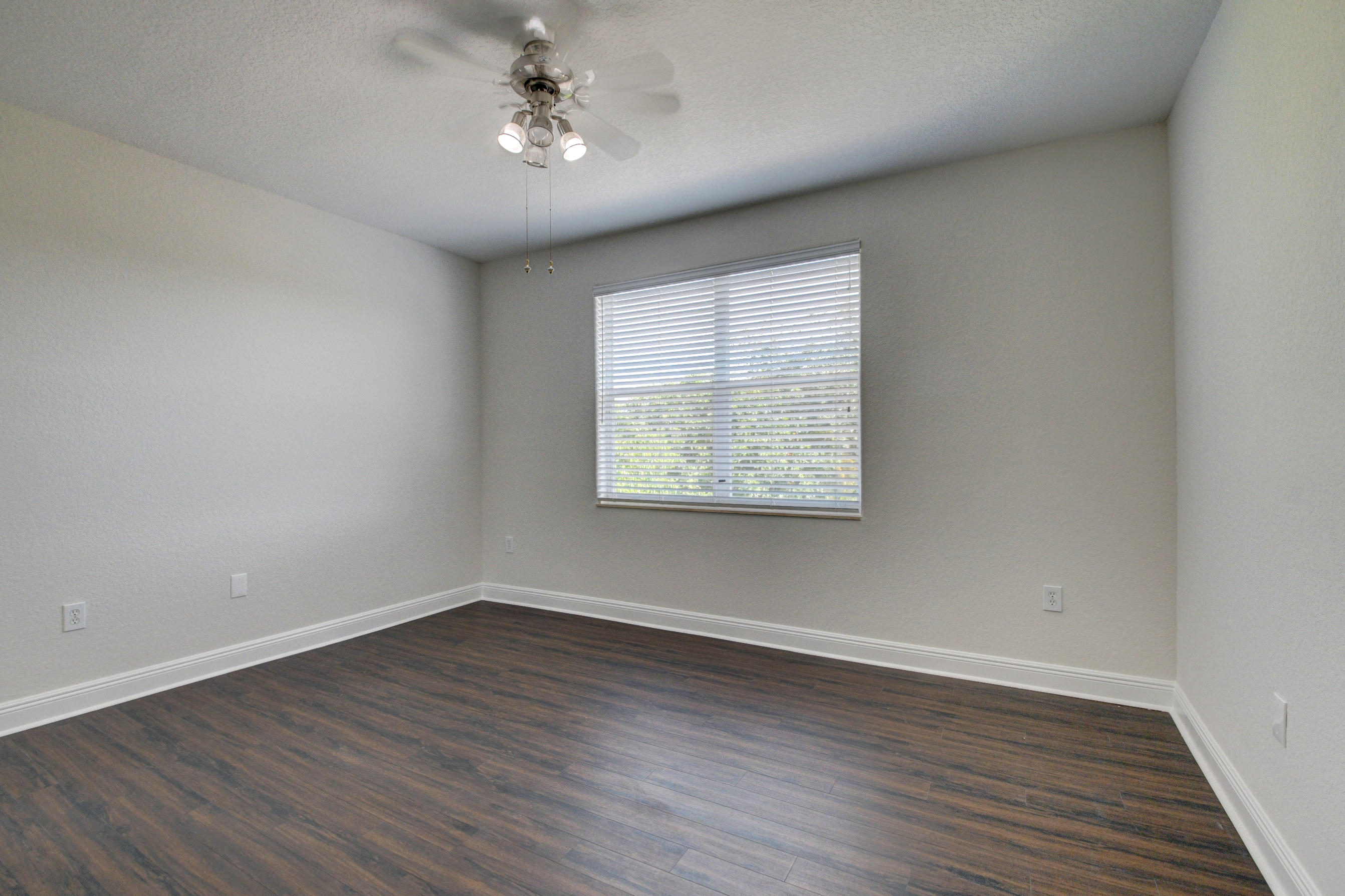 11785 Preservation Lane Boca Raton, FL 33498 - Photo 28 of 53 a view of an empty room with wooden floor and a window