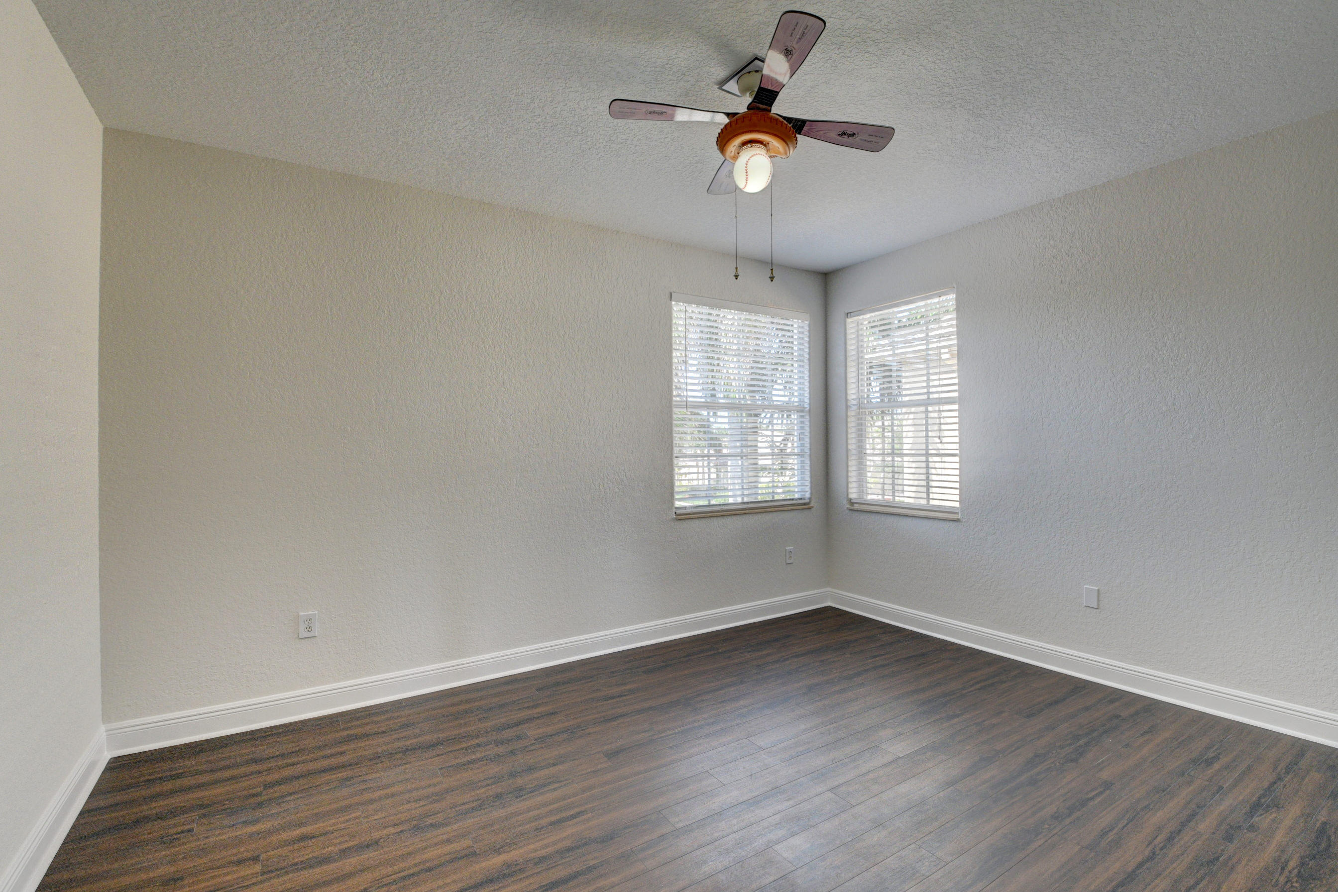 11785 Preservation Lane Boca Raton, FL 33498 - Photo 31 of 53 an empty room with wooden floor fan and windows