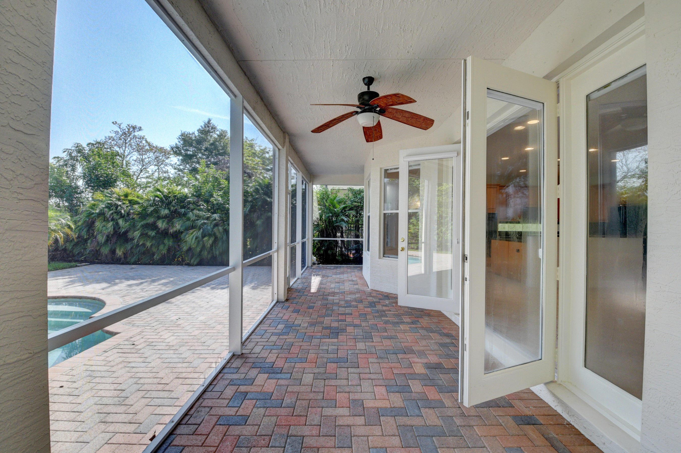 11785 Preservation Lane Boca Raton, FL 33498 - Photo 39 of 53 a view of a porch with a floor to ceiling window and a chandelier