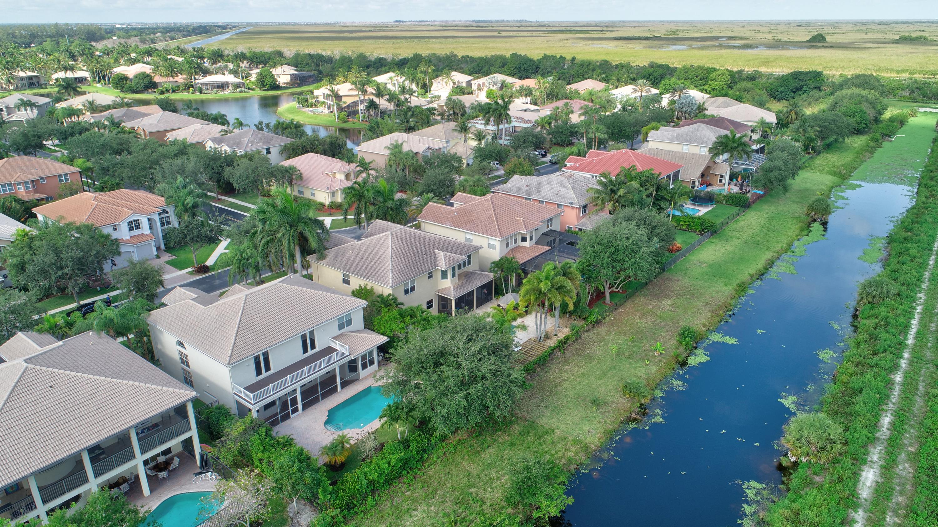11785 Preservation Lane Boca Raton, FL 33498 - Photo 48 of 53 an aerial view of lake and residential houses with outdoor space