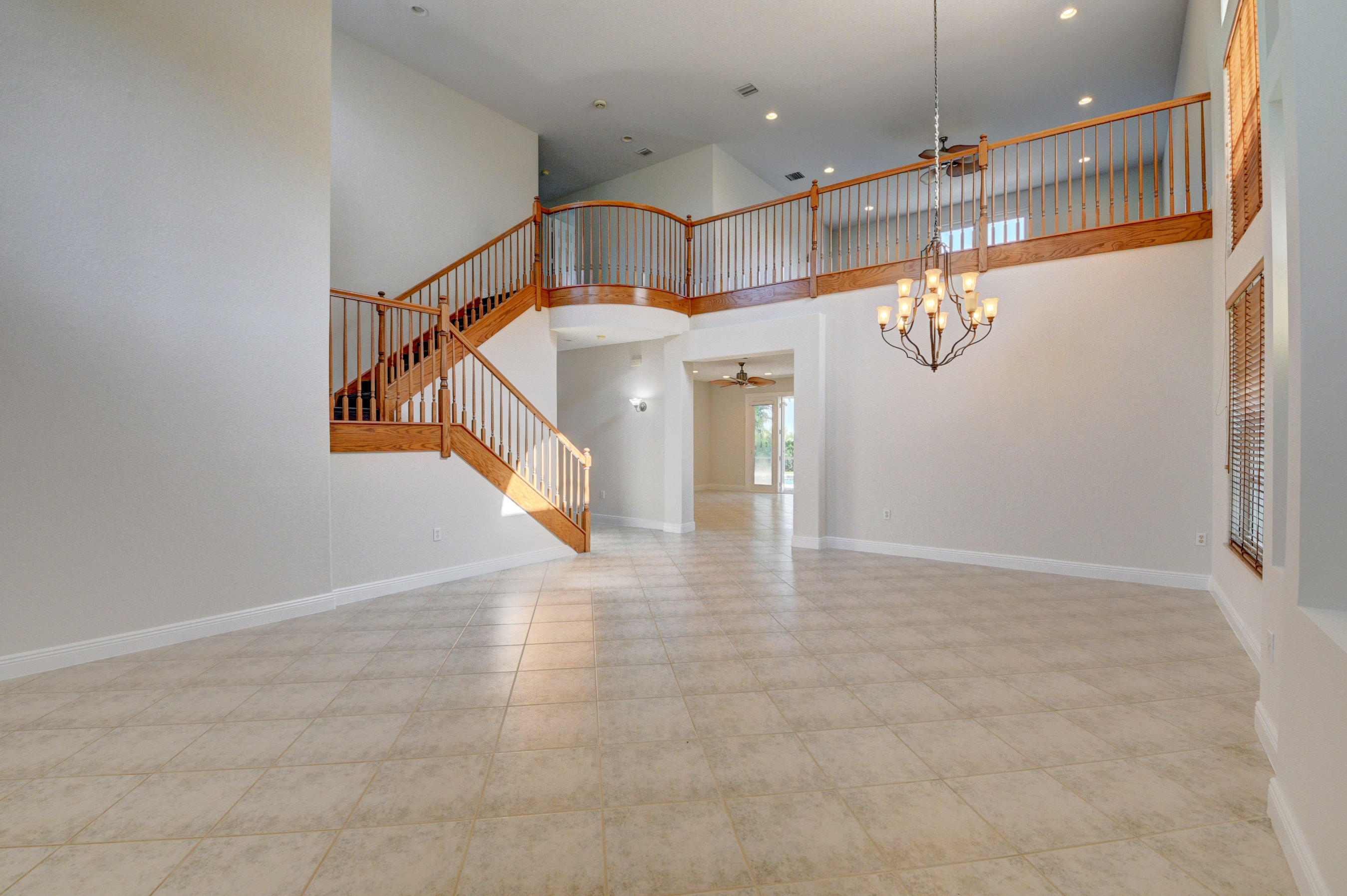 11785 Preservation Lane Boca Raton, FL 33498 - Photo 6 of 53 a view of a hallway with a chandelier