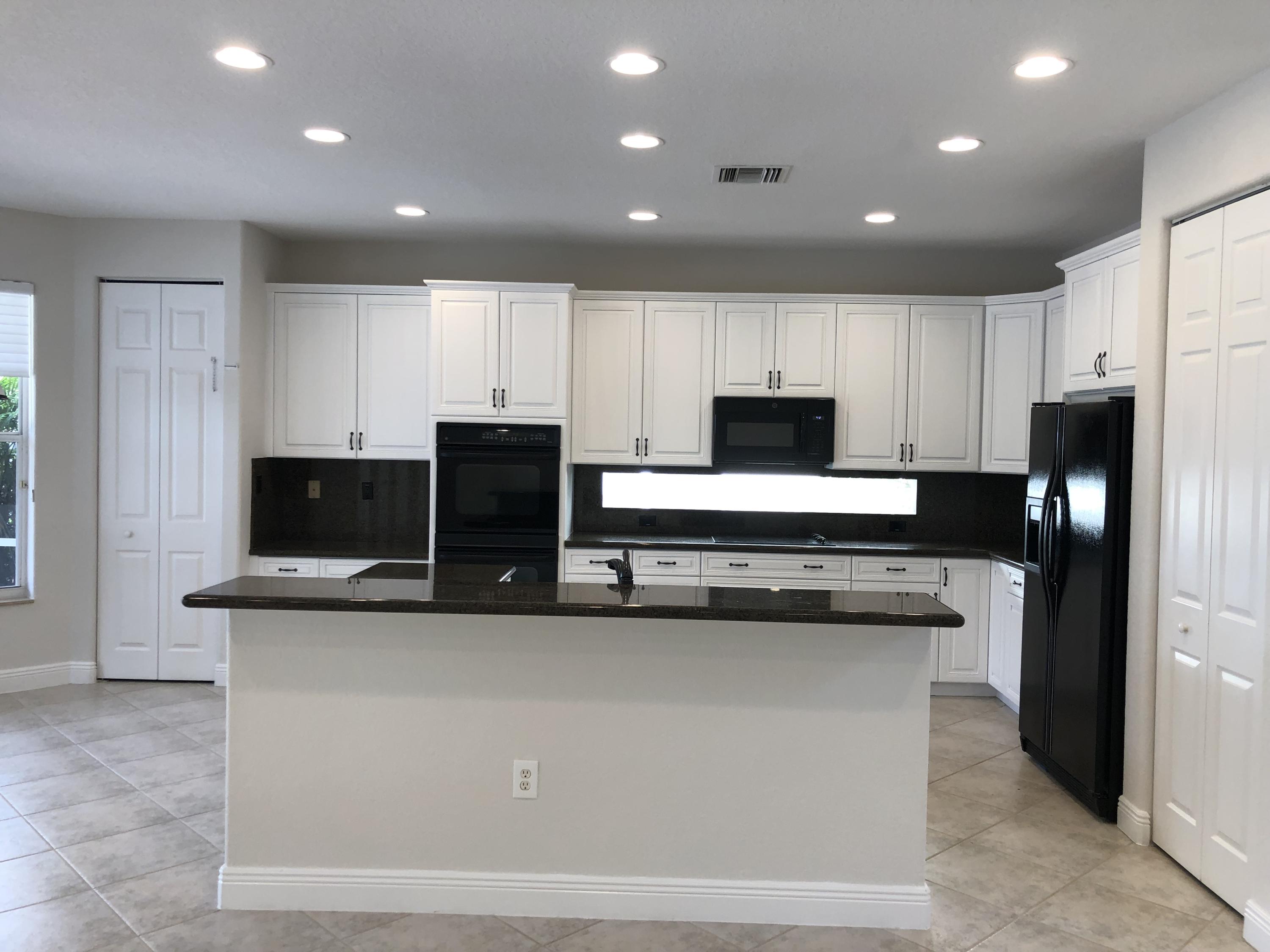 11785 Preservation Lane Boca Raton, FL 33498 - Photo 8 of 53 a kitchen with kitchen island stainless steel appliances and cabinets