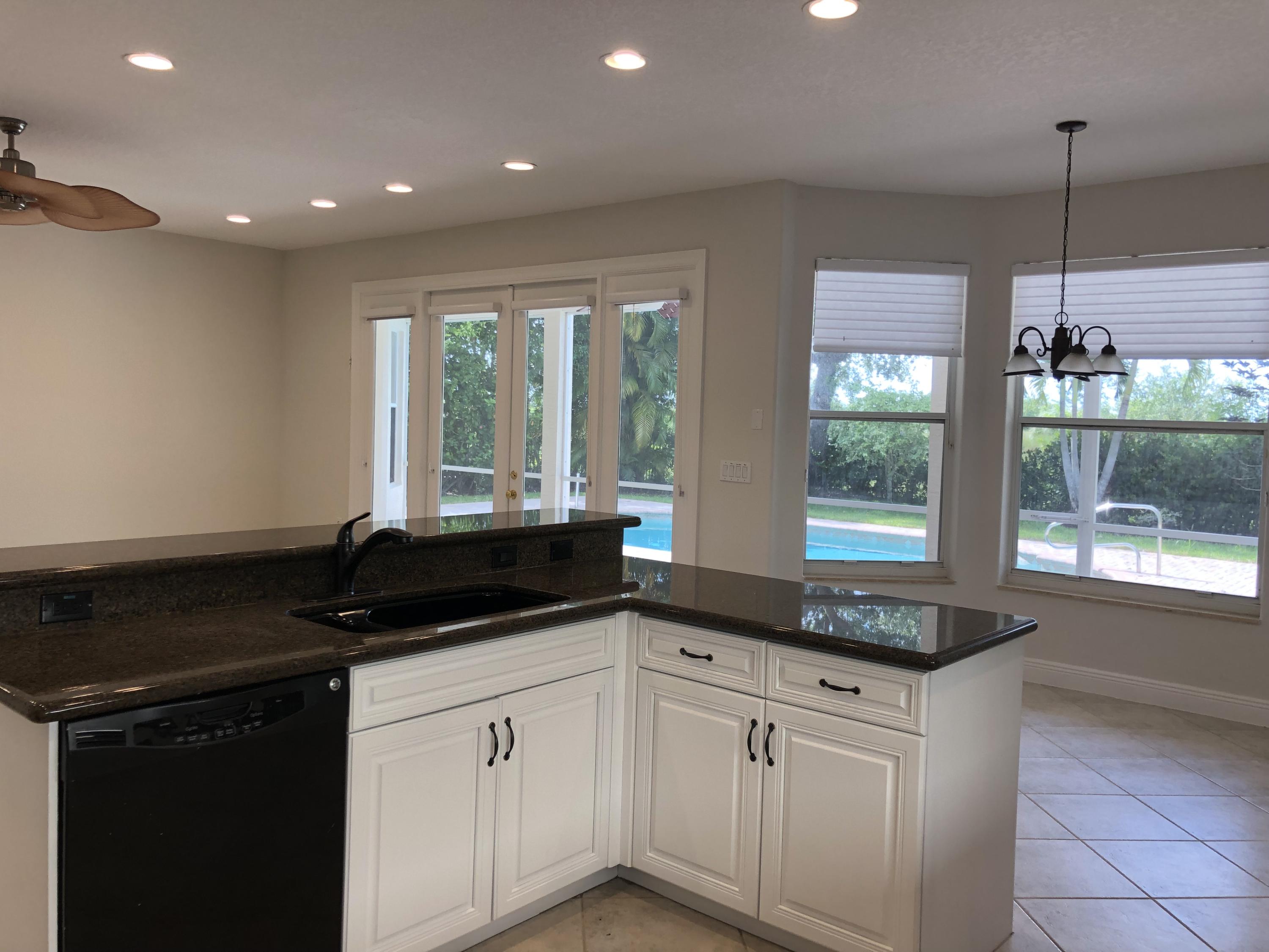 11785 Preservation Lane Boca Raton, FL 33498 - Photo 10 of 53 a kitchen with a sink and large window
