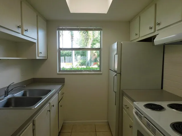 a kitchen with a refrigerator and a stove