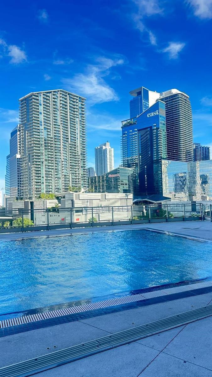 92 Southwest 3rd Street, Unit 1908 Miami, FL 33130 - Photo 17 of 18 a view of a living room and kitchen with furniture