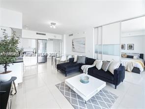 92 Southwest 3rd Street, Unit 1908 Miami, FL 33130 - Photo 3 of 18 a living room with furniture and a table