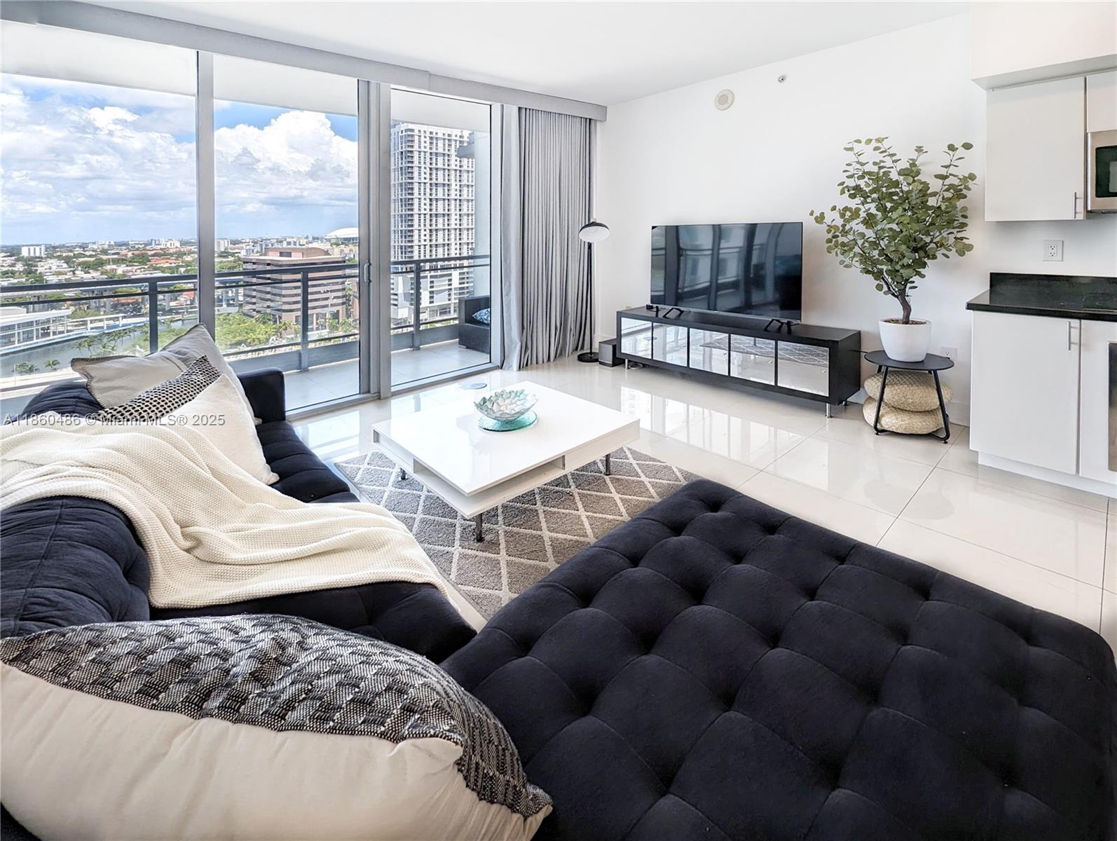 92 Southwest 3rd Street, Unit 1908 Miami, FL 33130 - Photo 5 of 18 a bedroom with furniture and a large window