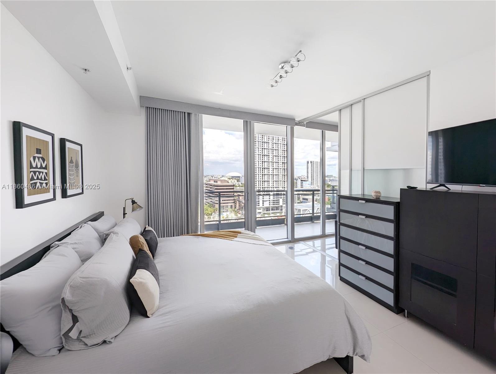 92 Southwest 3rd Street, Unit 1908 Miami, FL 33130 - Photo 7 of 18 a bedroom with a bed and a flat screen tv