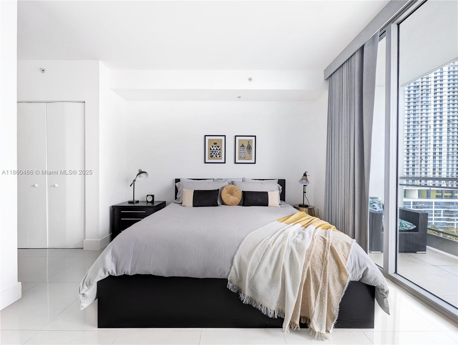 92 Southwest 3rd Street, Unit 1908 Miami, FL 33130 - Photo 9 of 18 a bedroom with a bed and painting on the wall