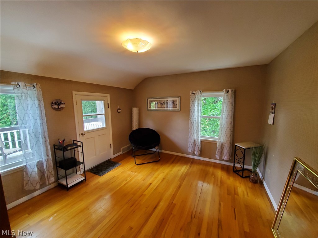 8121 Johnnycake Ridge Road Mentor, OH 44060 - Photo 18 of 39 Unfurnished room featuring lofted ceiling and light hardwood / wood-style floors