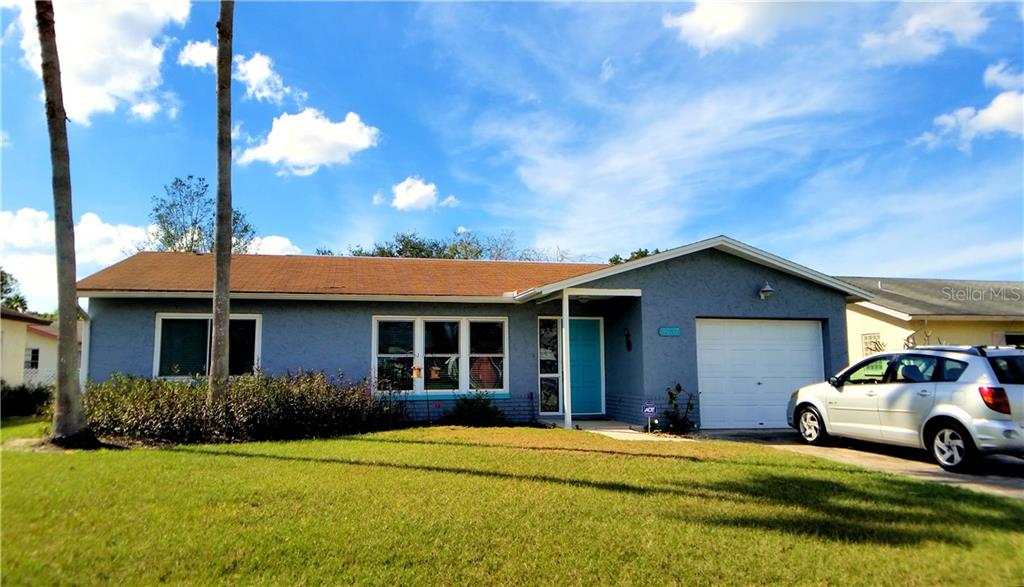 5037 Brookside Lane New Port Richey, FL 34653 - Photo 1 of 1 a front view of a house with a garden