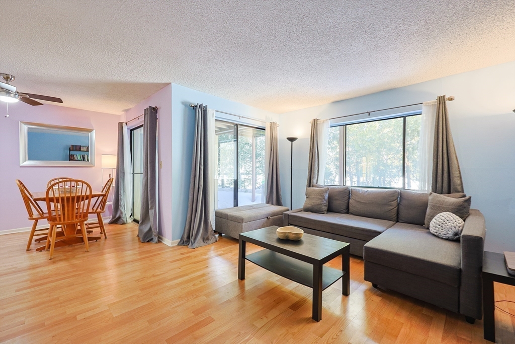 276 Trailside Way, Unit 276 Ashland, MA 01721 - Photo 11 of 32 a living room with furniture and wooden floor