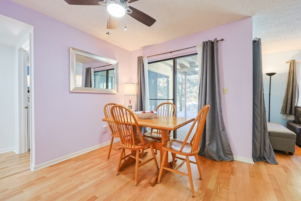 276 Trailside Way, Unit 276 Ashland, MA 01721 - Photo 13 of 32 a view of a dining room with furniture window and wooden floor