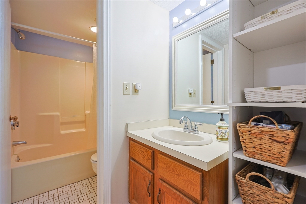 276 Trailside Way, Unit 276 Ashland, MA 01721 - Photo 18 of 32 a bathroom with a sink a vanity and a mirror
